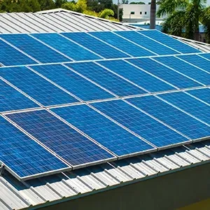 Blue solar panels on a rooftop in bright daylight