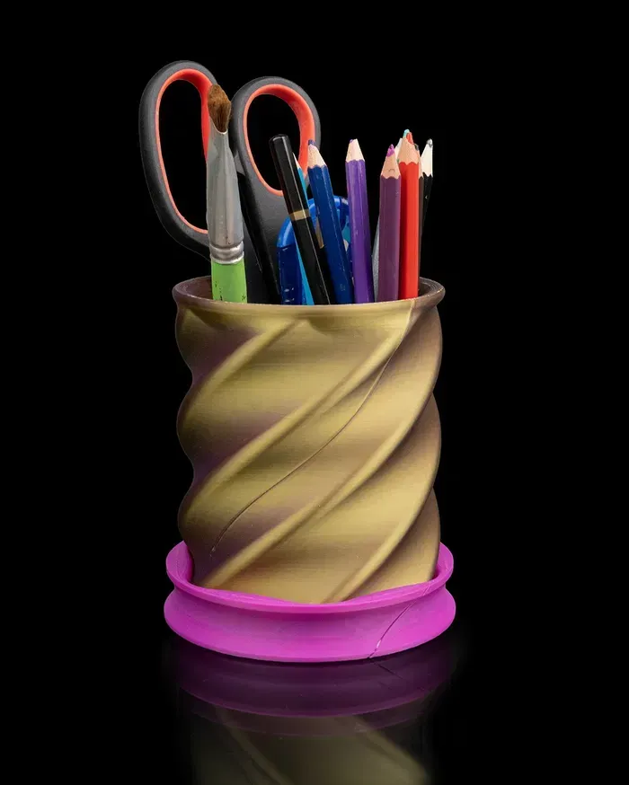 A pencil holder filled with pencils scissors and brushes