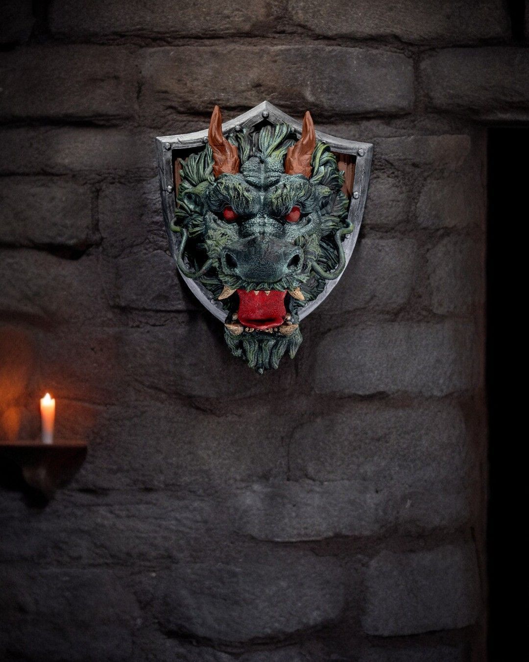 A statue of a dragon on a shield on a brick wall