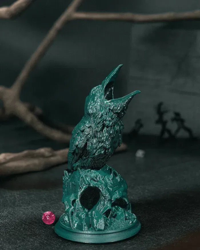 A statue of a bird sitting on top of a skull.