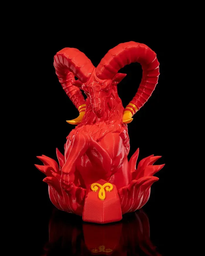 A red statue of a goat with horns on a black background.