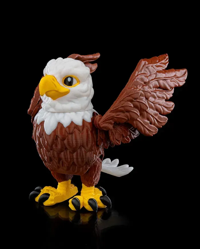 A toy bald eagle with its wings outstretched on a black background.