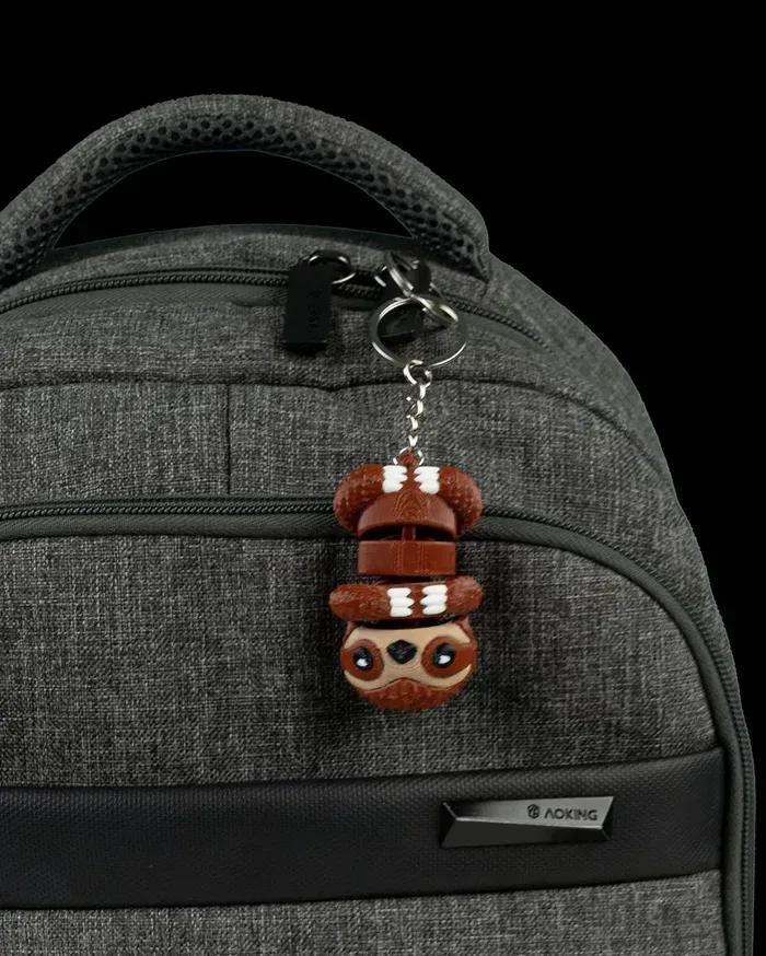 A close up of a backpack with a keychain attached to it.