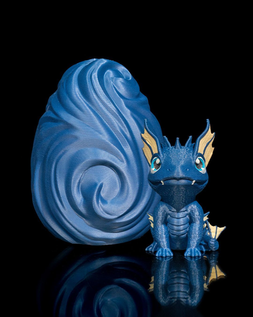 A blue dragon figurine is sitting next to a blue squirrel figurine.