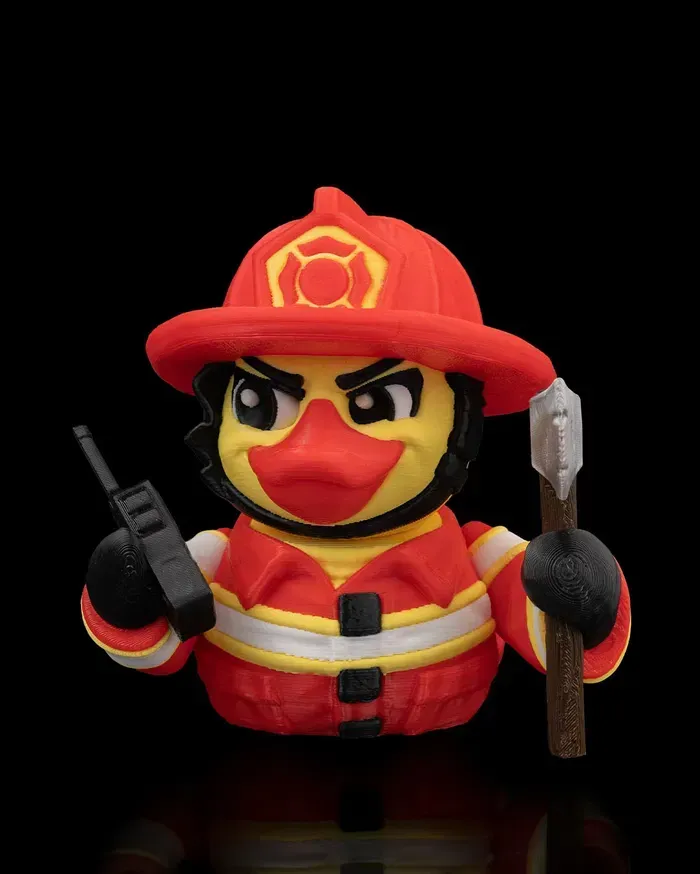 A rubber duck dressed as a fireman is holding a walkie talkie and a stick.