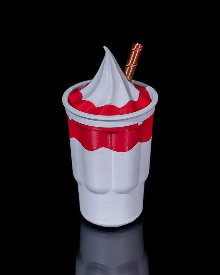 A cup of ice cream with a straw in it