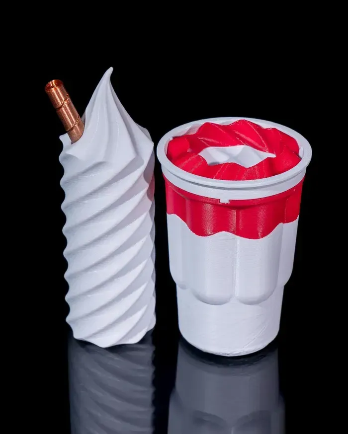 A cup of ice cream with a straw in it