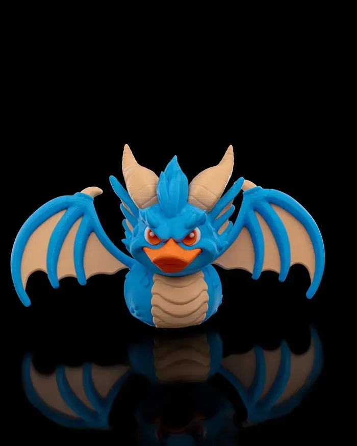 A blue rubber duck with wings and horns on a black background