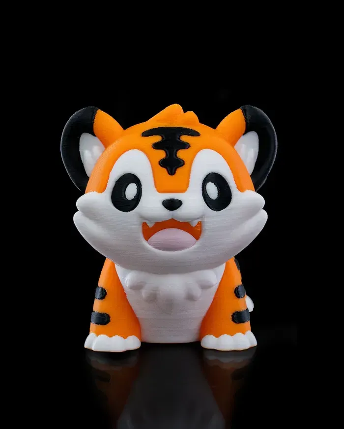 A small orange and white tiger figurine with a black background