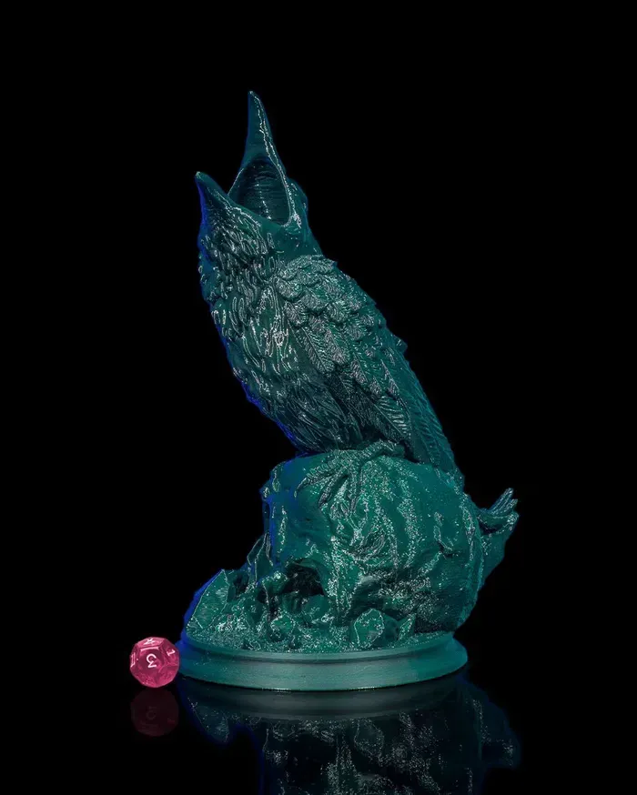 A statue of a bird sitting on top of a skull.