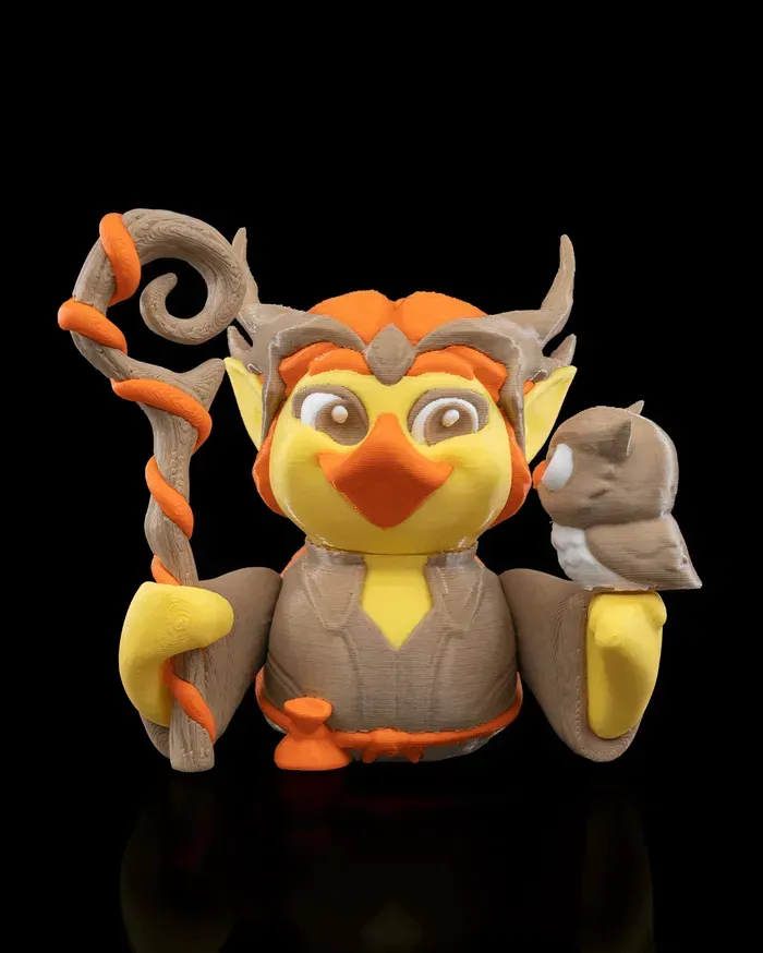 A figurine of an owl holding a stick and a bird.