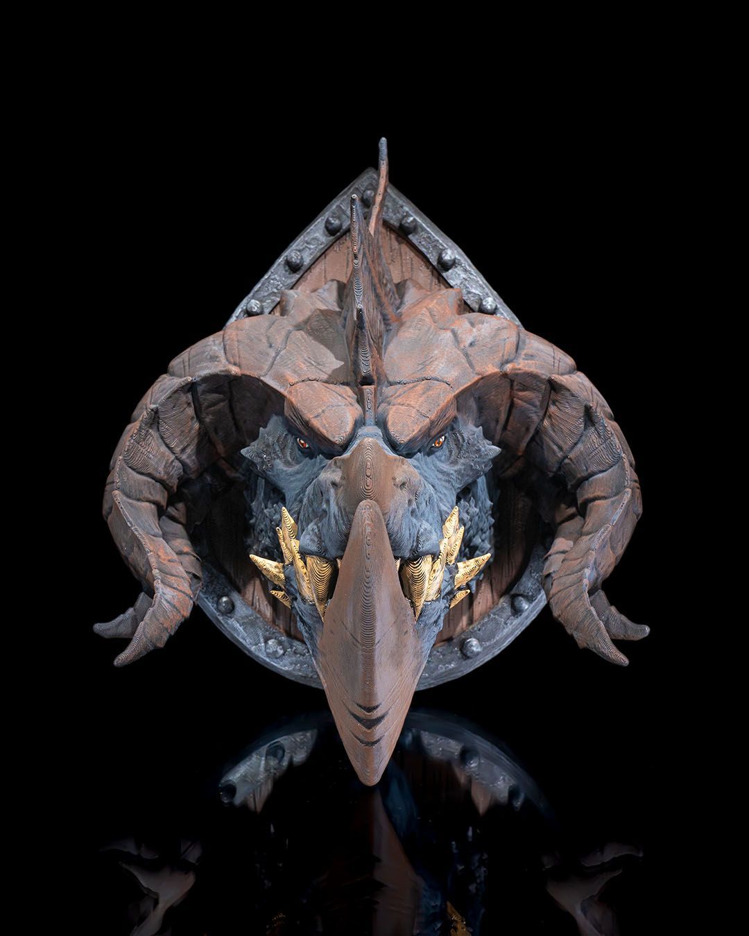 A close up of a statue of a dragon on a black surface.
