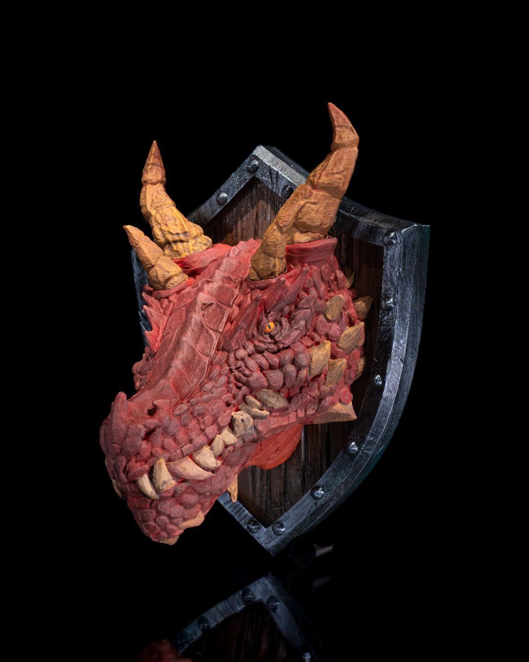 A dragon 's head is mounted on a wooden shield.