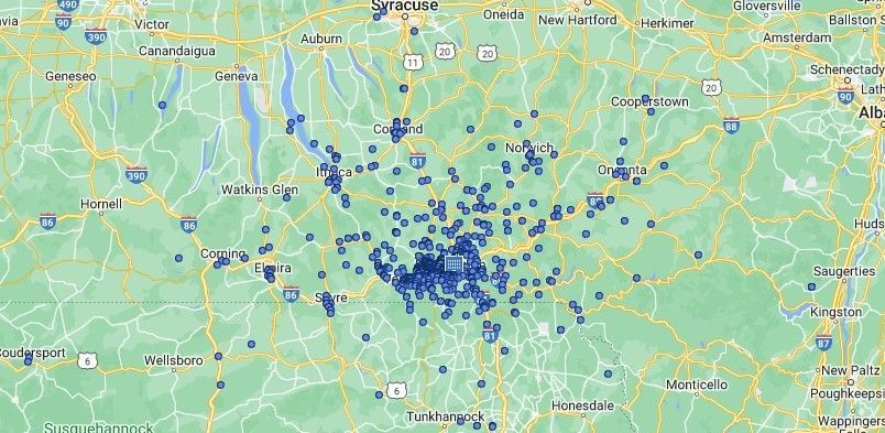 Map with many blue markers clustered around a central city and scattered across surrounding roads.