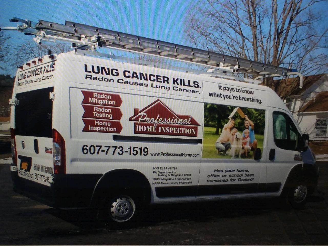 White van with a lung cancer awareness ad and home inspection branding parked outdoors.