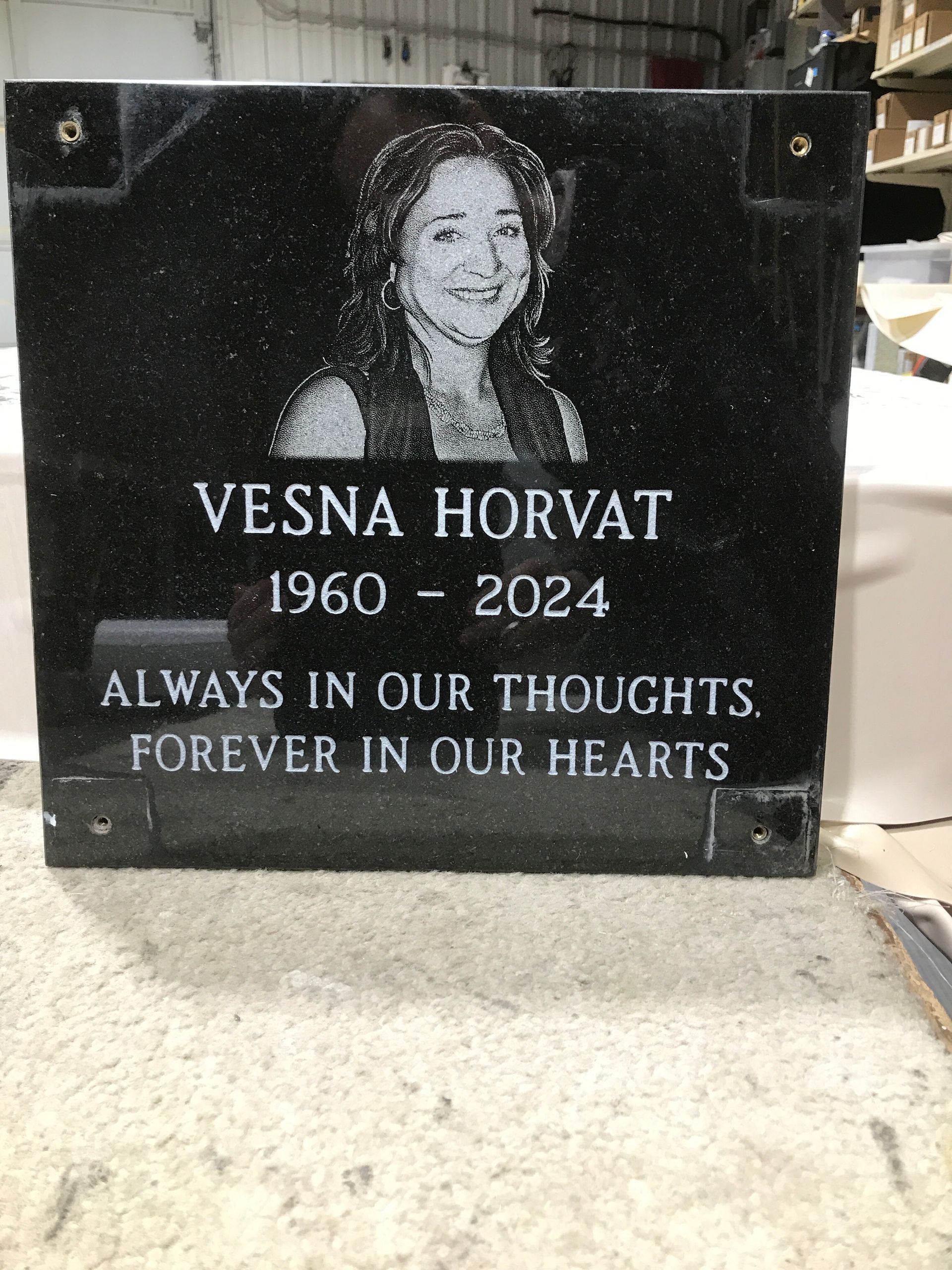 Black memorial plaque with a portrait and text for Vesna Horvat, 1960–2024, “Always in our thoughts, forever in our hearts”