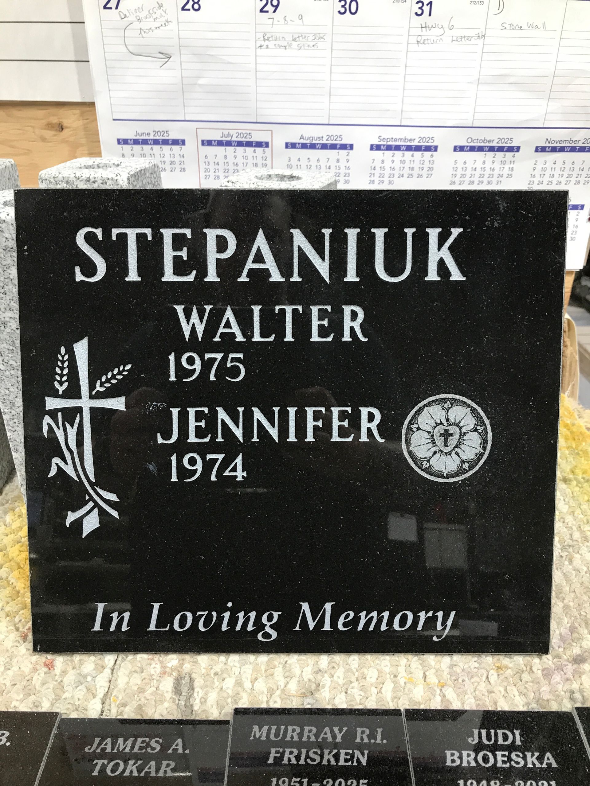 Black gravestone for the Stepaniuk family with names Walter and Jennifer, “In Loving Memory” etched below