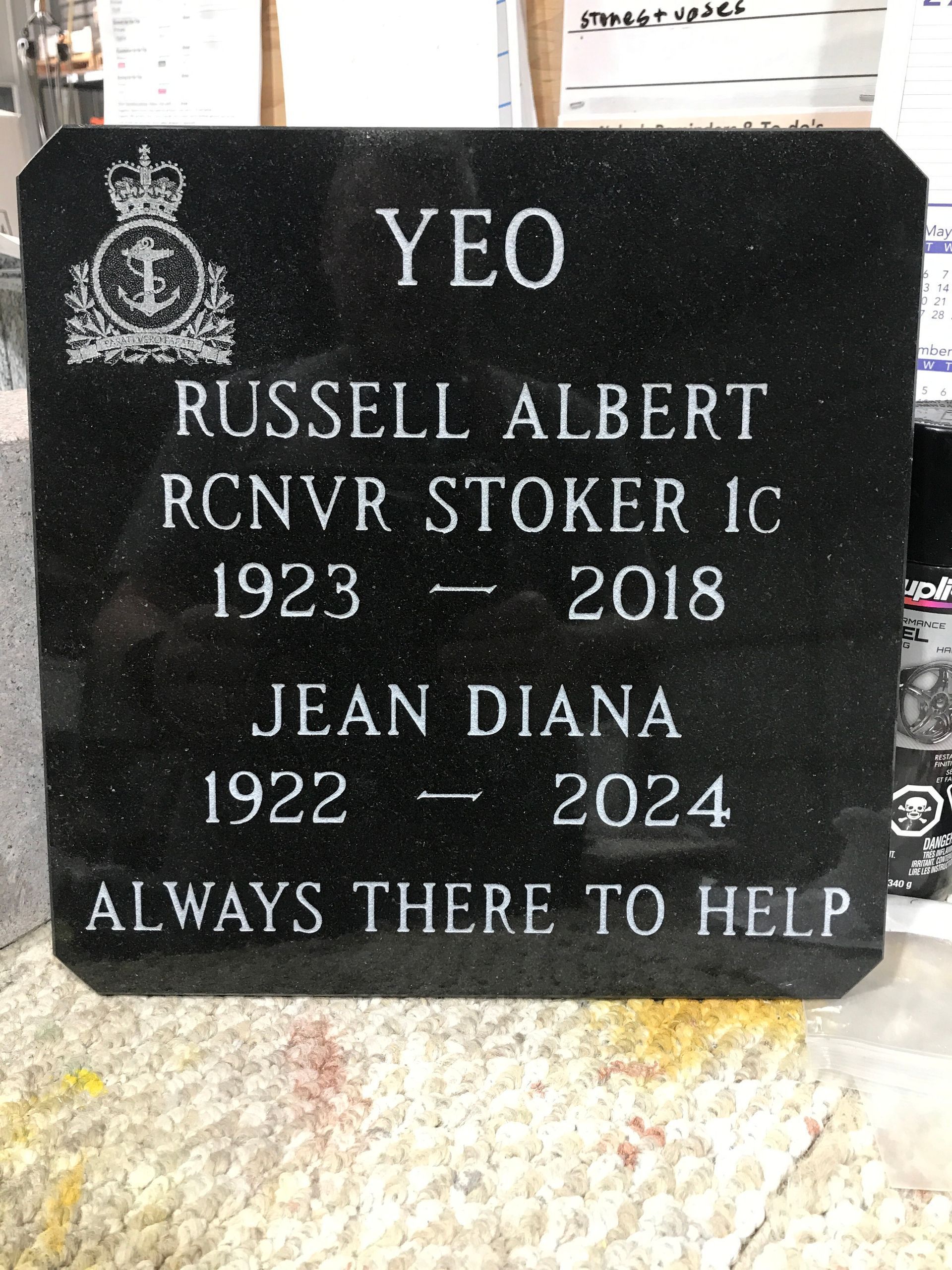Black granite memorial plaque for Russell Albert and Jean Diana with military emblem and the words “Always there to help”