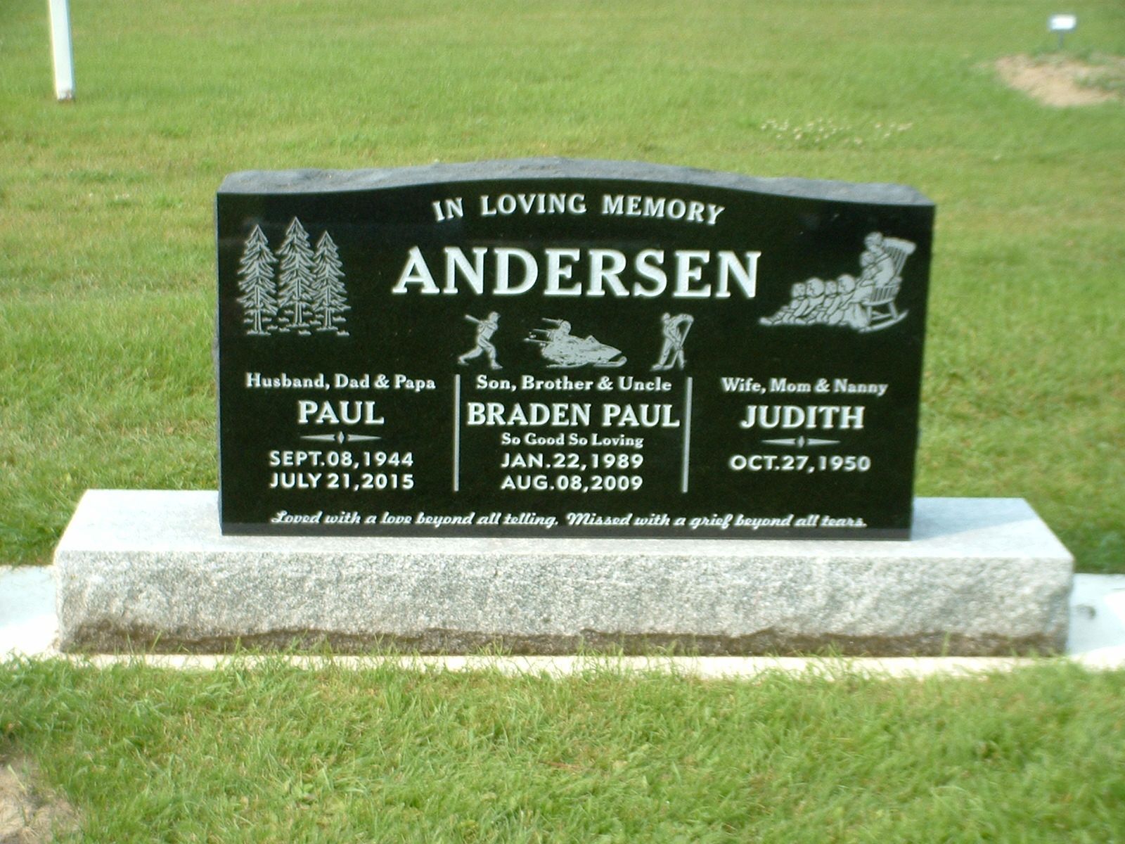 Black Anderson family memorial headstone on a grassy lawn with engraved names and dates