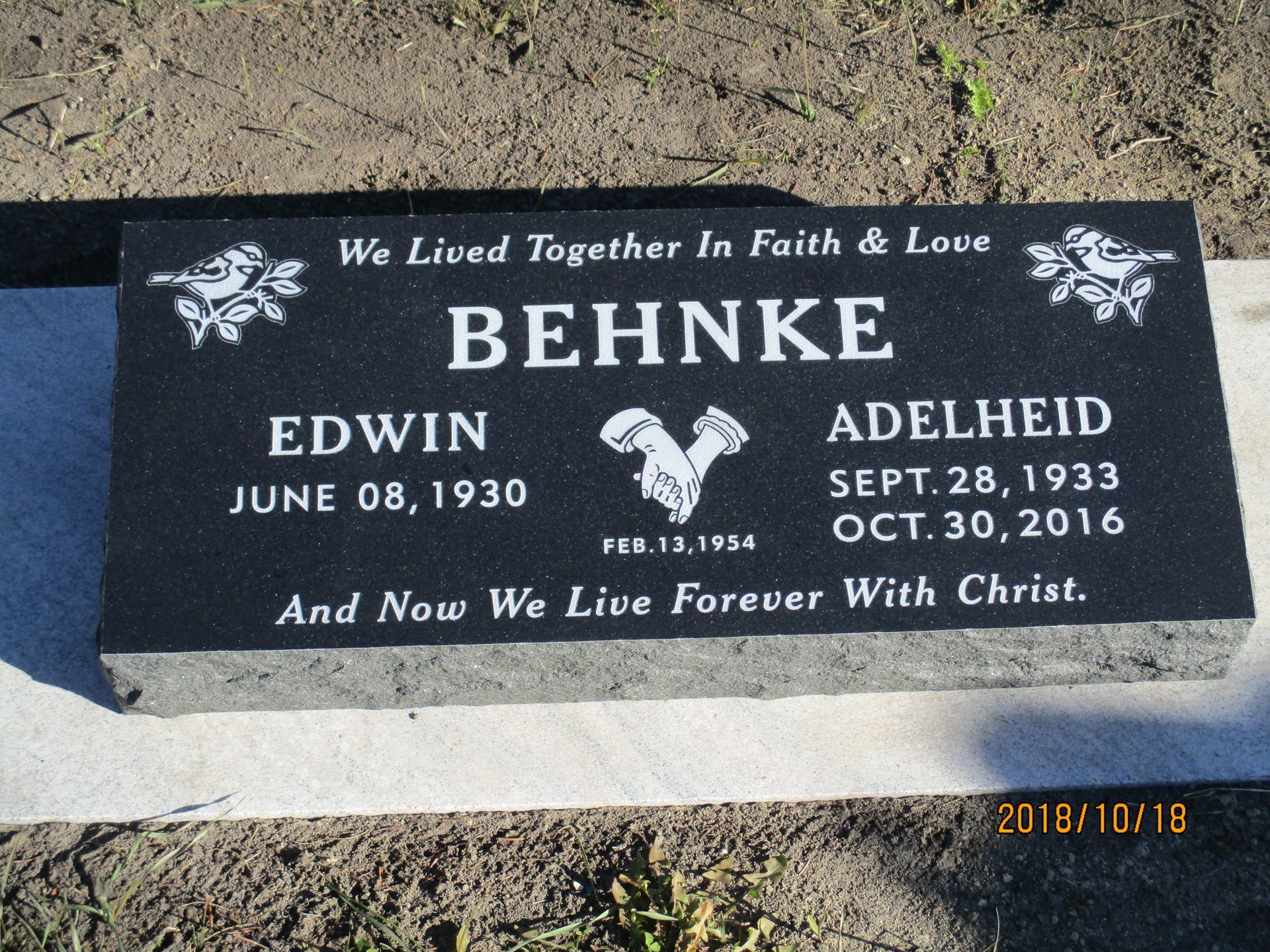 Black engraved memorial stone for Behnke with names Edwin and Adelhied and dates.
