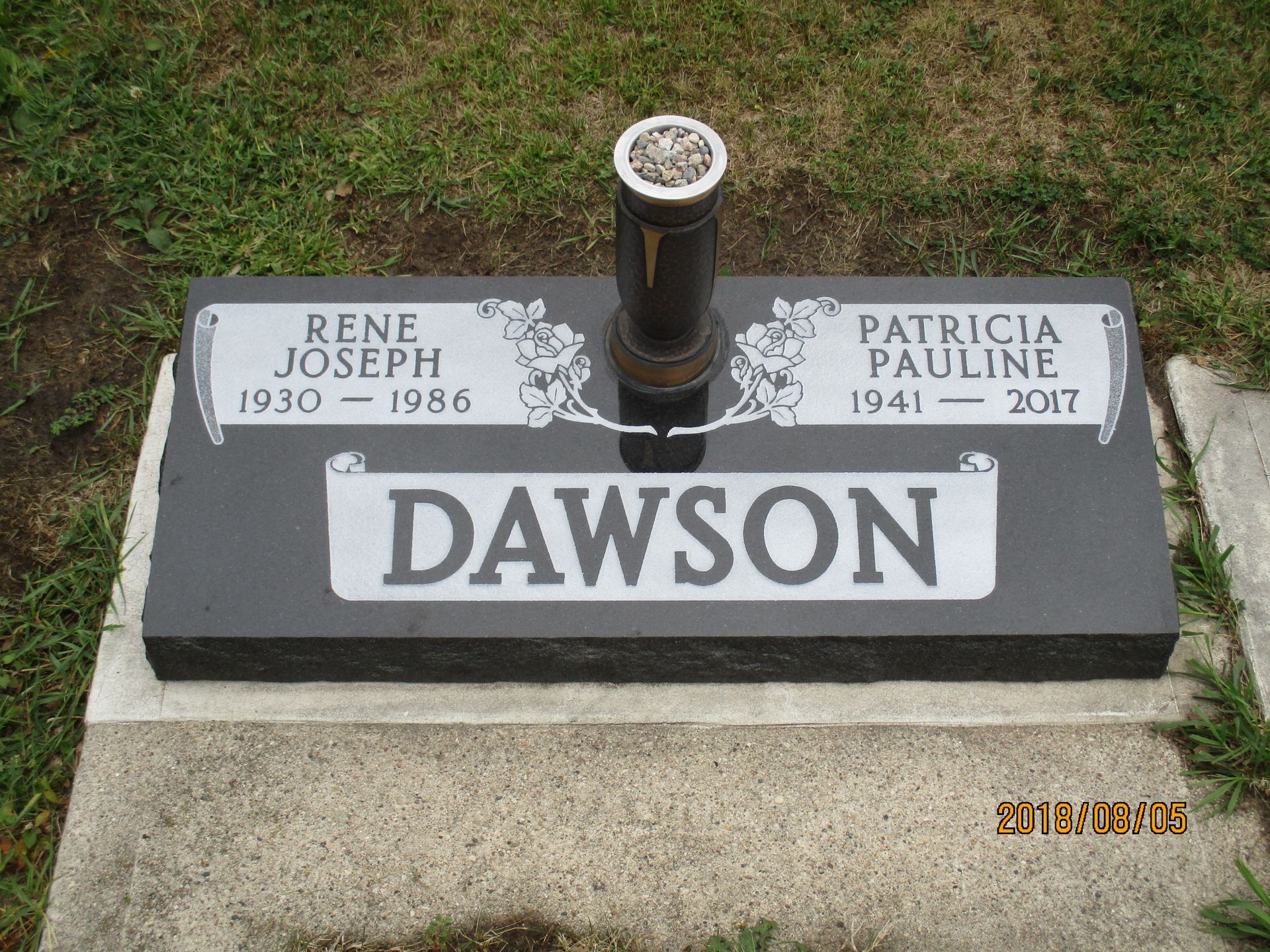 Dawson family gravestone with black monument and engraved names on a lawn