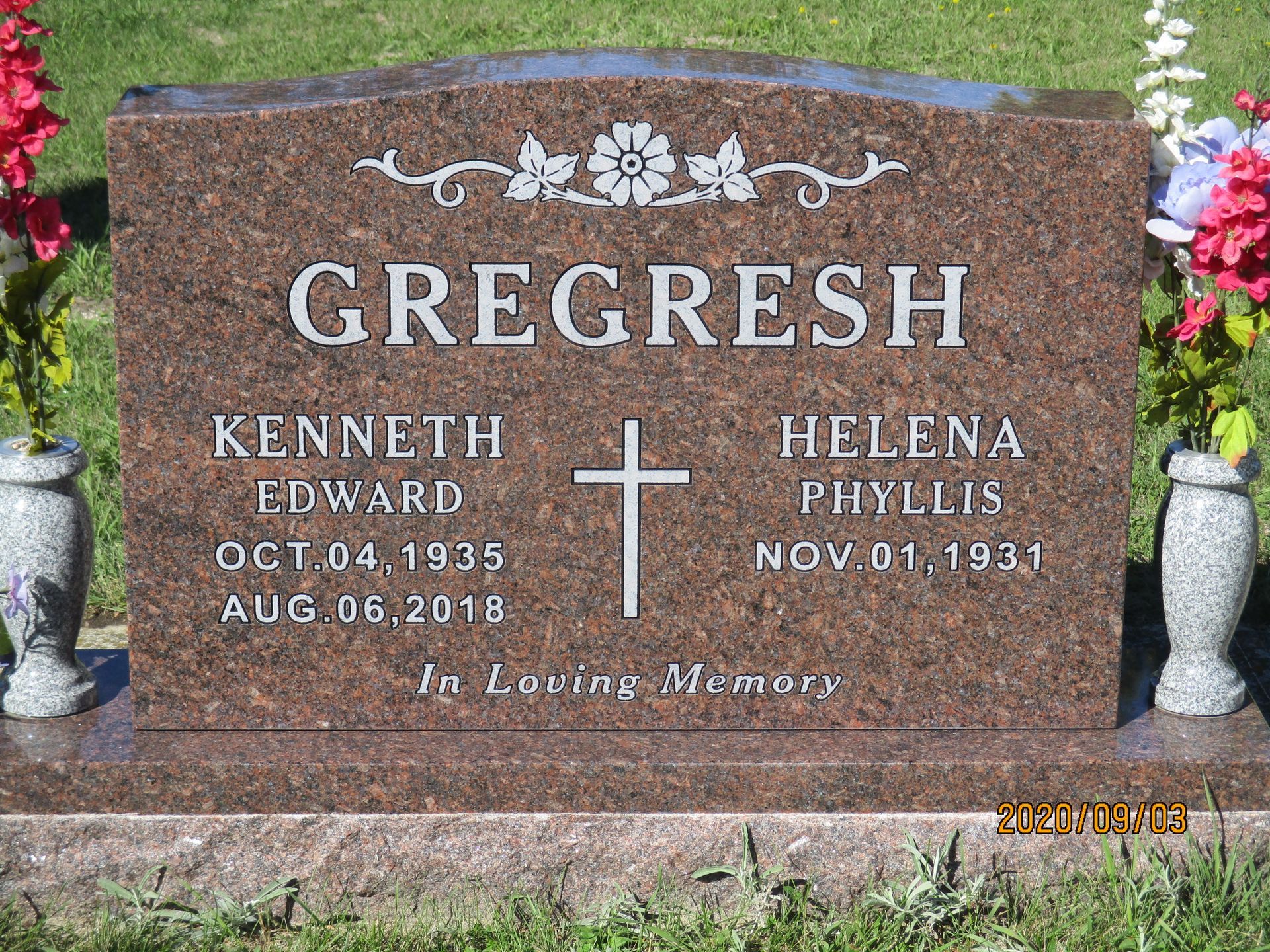 GREGRESH gravestone with names Kenneth Edward and Helen Phyllis, cross and floral engraving