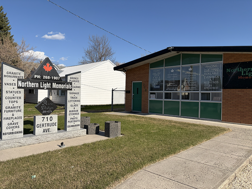 North Mt. Morris church entrance with sign, brick building, and sidewalk under a clear blue sky