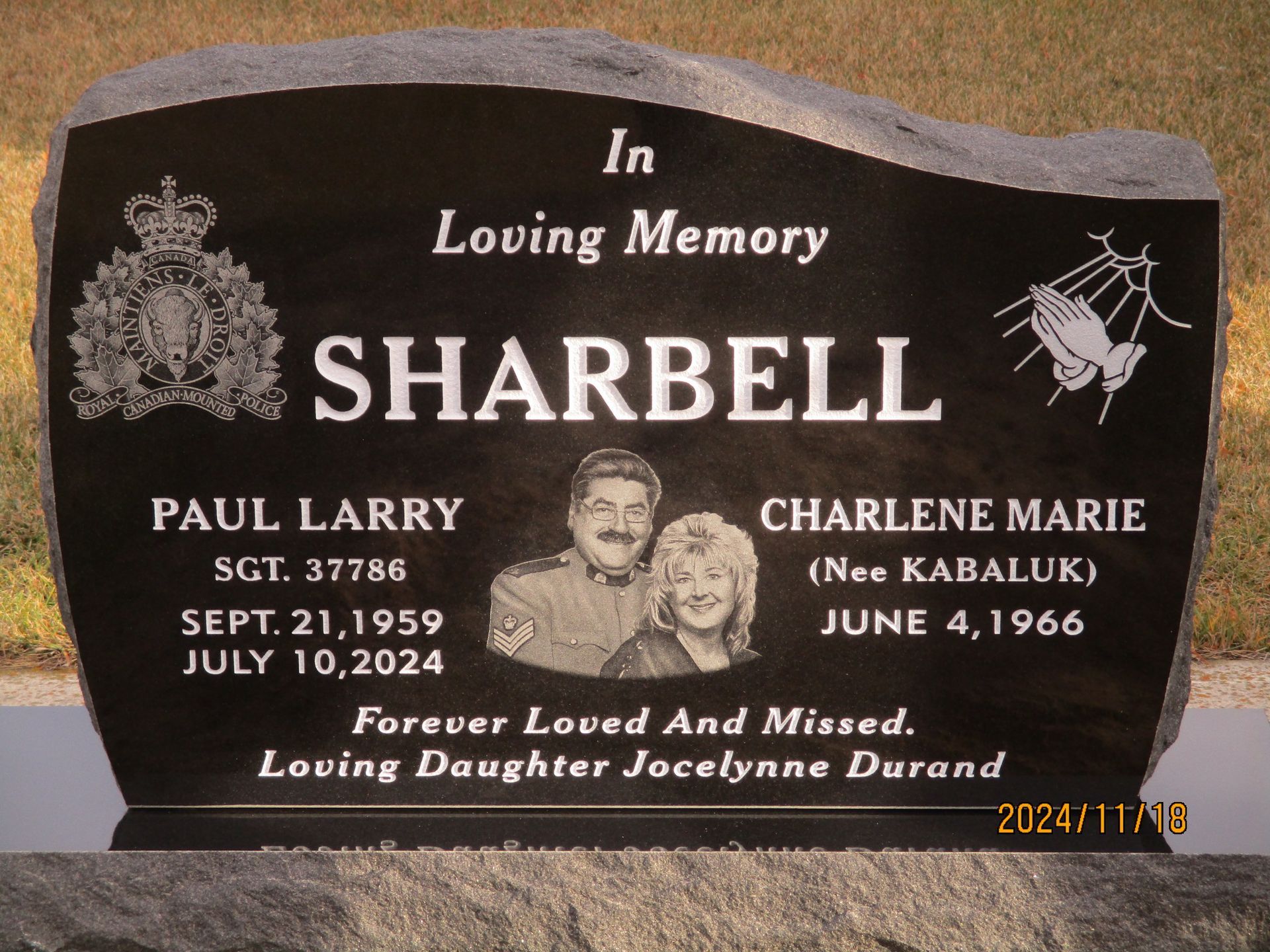 Black memorial gravestone for Sharbell with names Paul Larry and Charlene Marie, engraved in gold lettering.