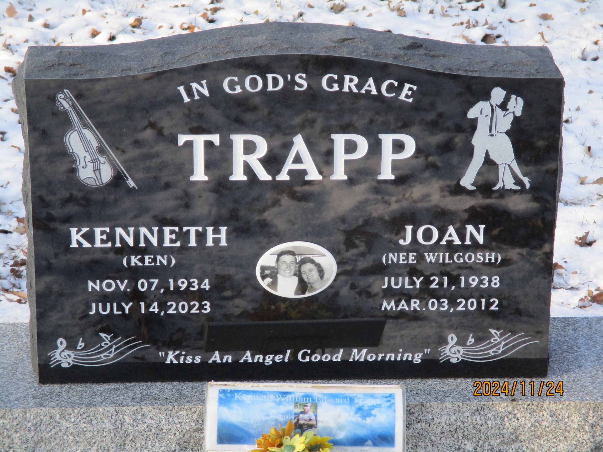 Black granite memorial headstone engraved “In God’s Grace” and “Trapp” with two names and dates