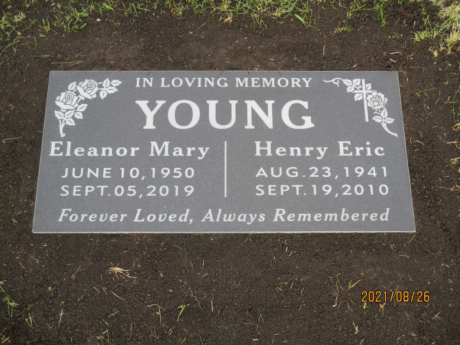 Gray memorial plaque for Eleanor Mary and Henry Eric Young, with dates and “In Loving Memory” text.