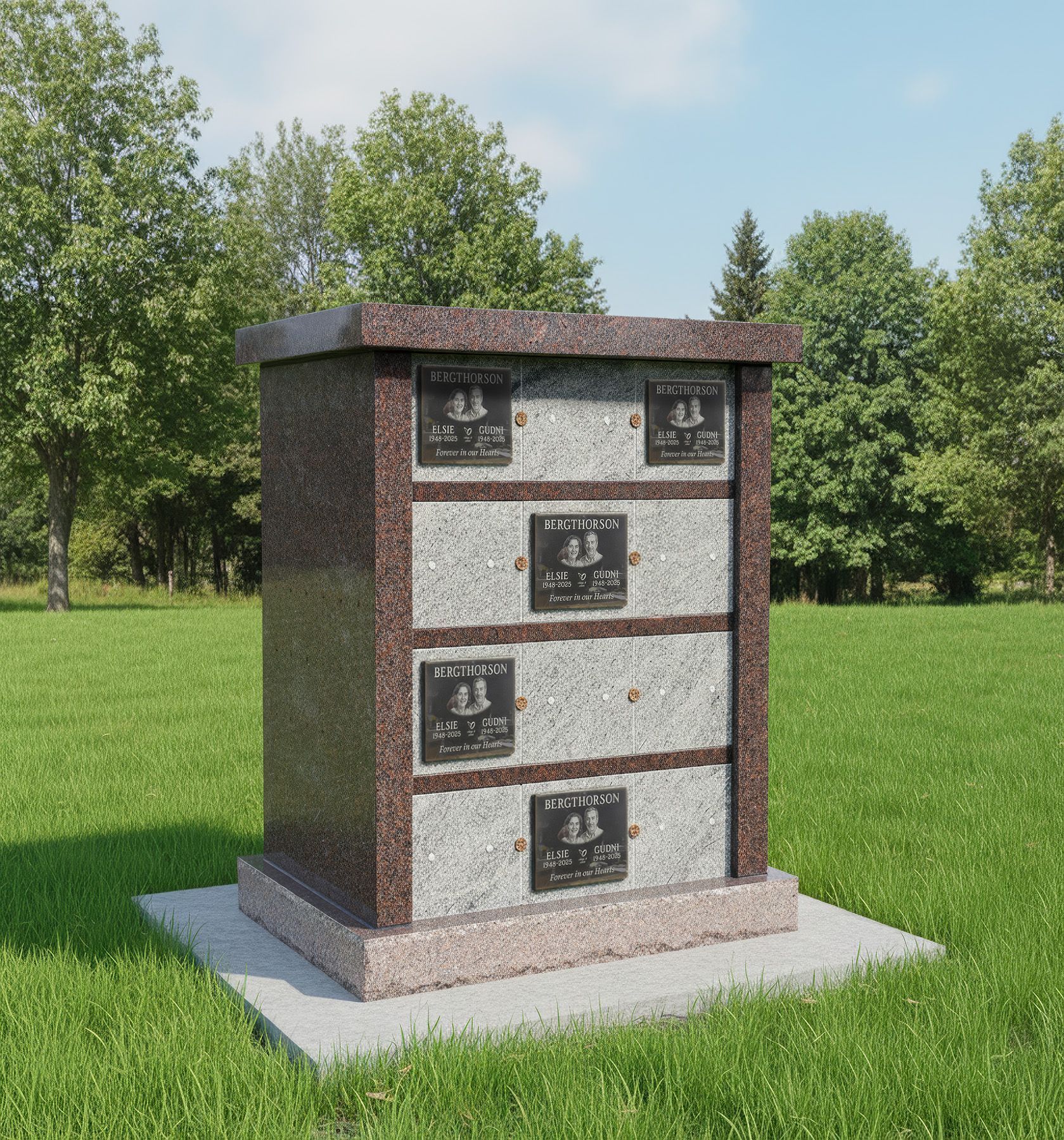 Small brick columbarium or memorial monument on a concrete base in a grassy park.