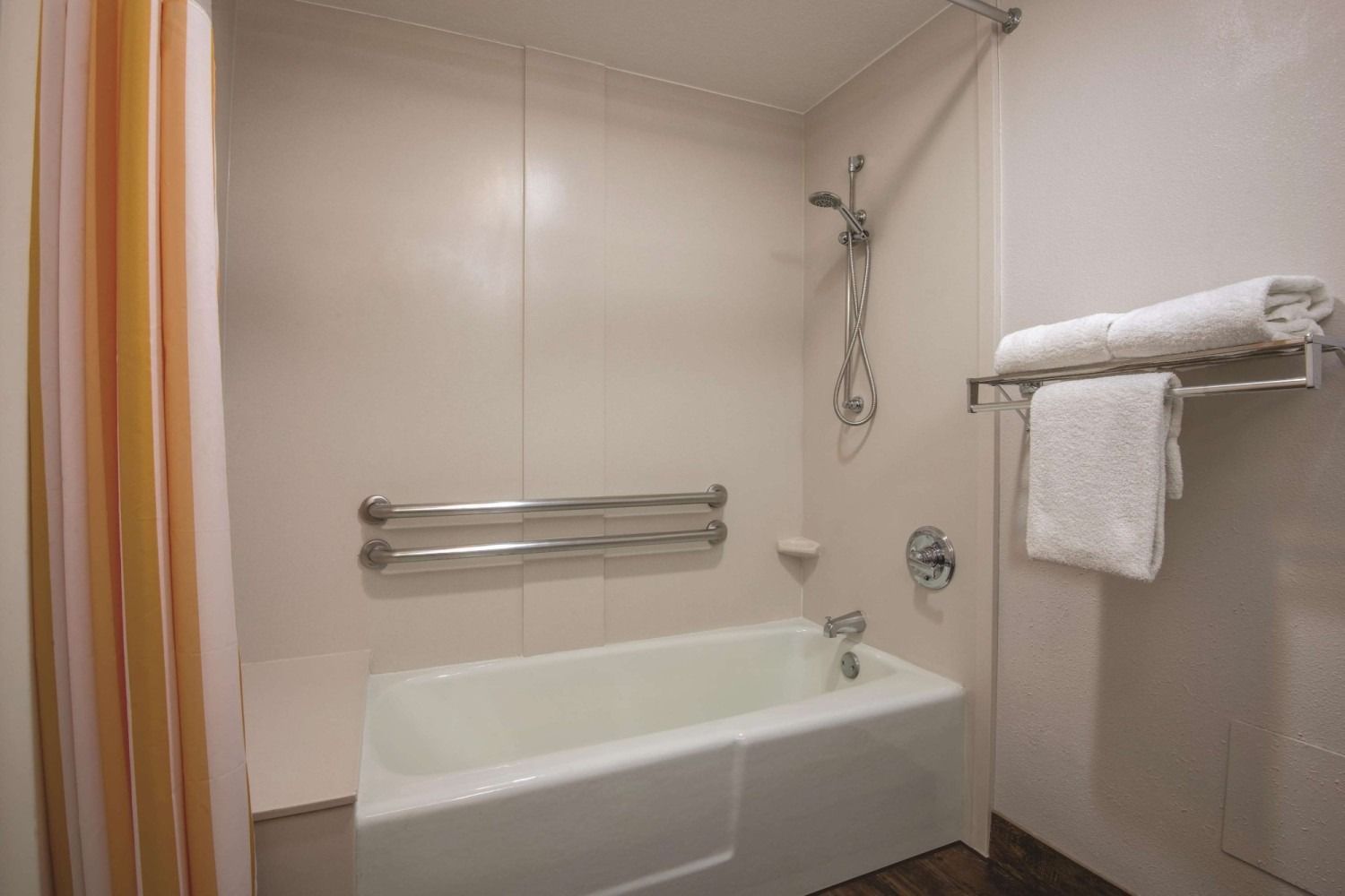 A bathroom with a bathtub and a shower.