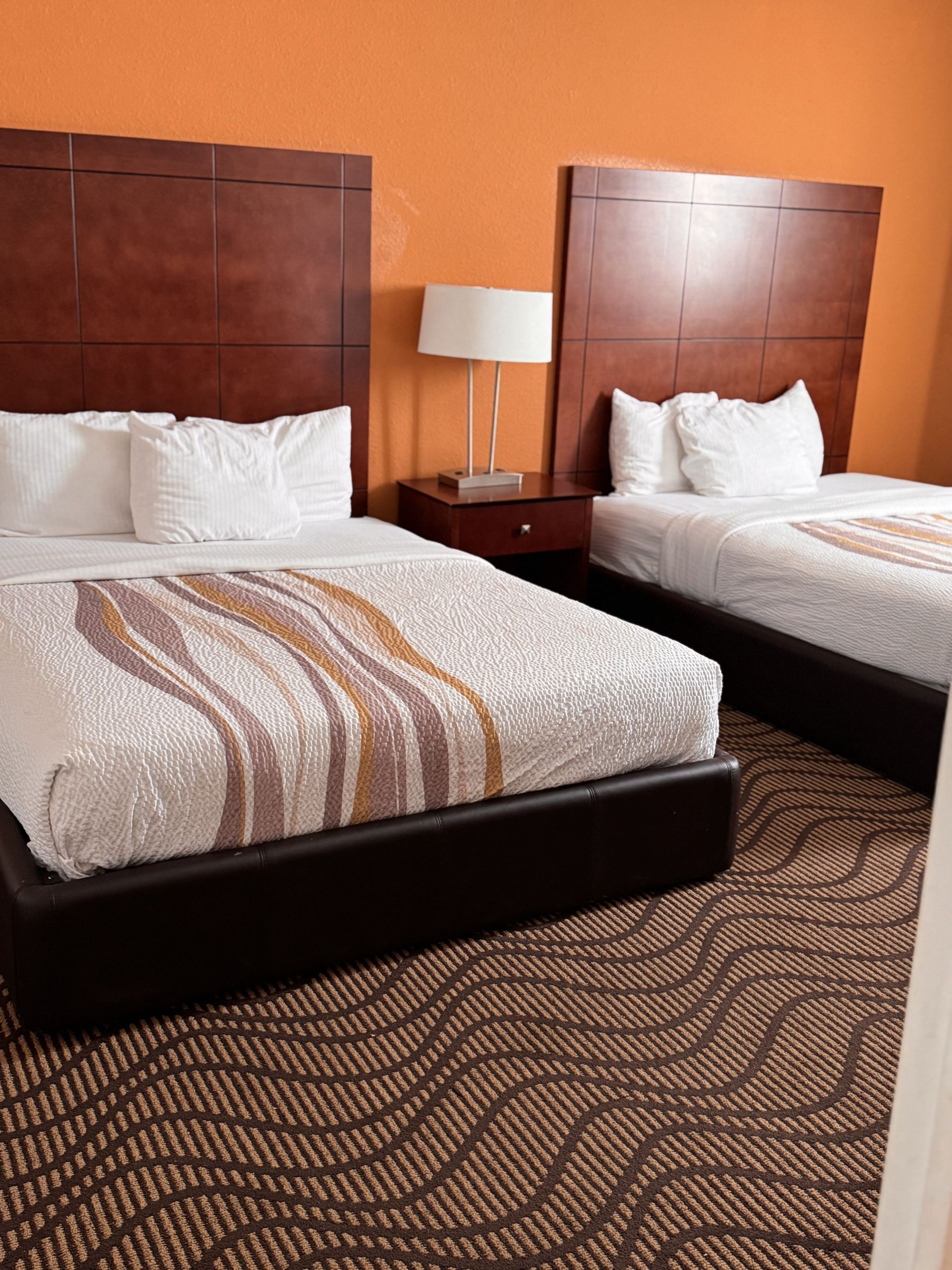 A bedroom with a bed and a ceiling fan