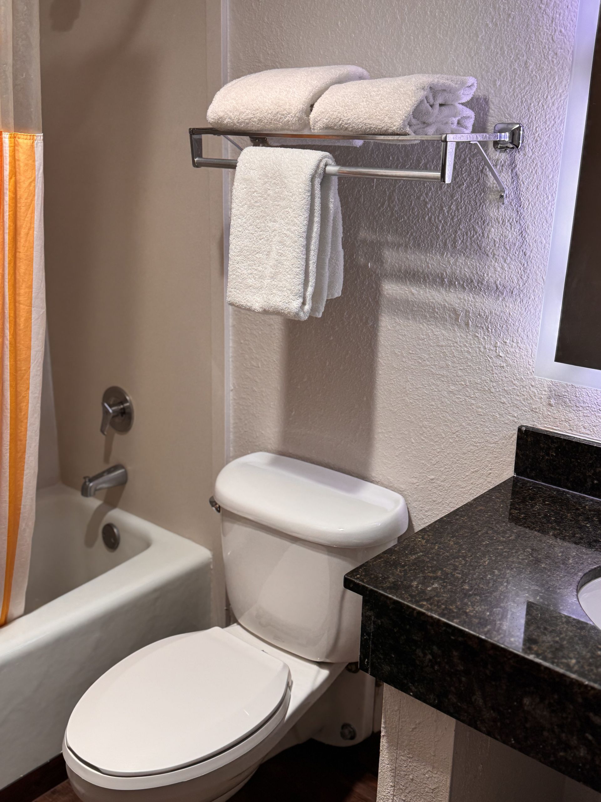 A bathroom with a toilet a sink and a bathtub