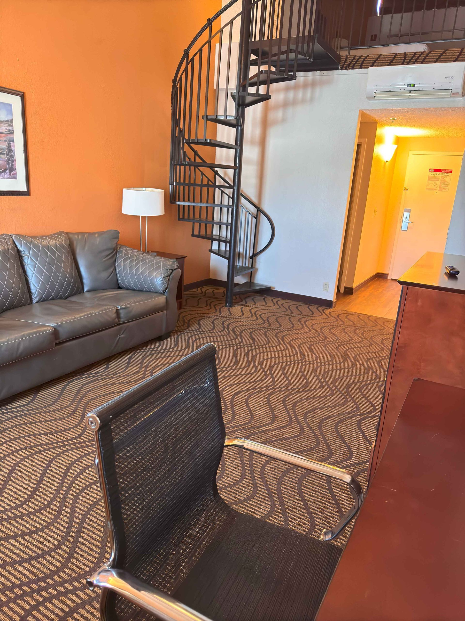A living room with a spiral staircase and a couch