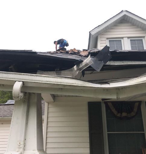 A hole in the roof with a ladder in it