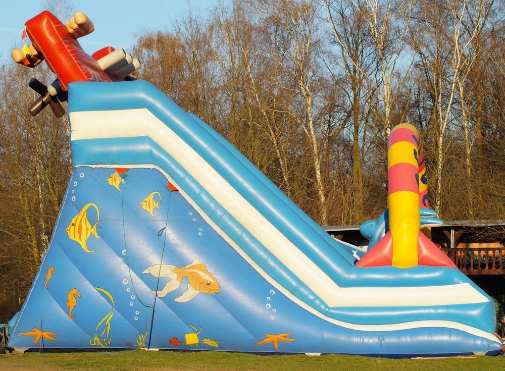 A Young Boy is Sitting on Top of a Bouncy House — Fun Time Amusements in Mackay, QLD