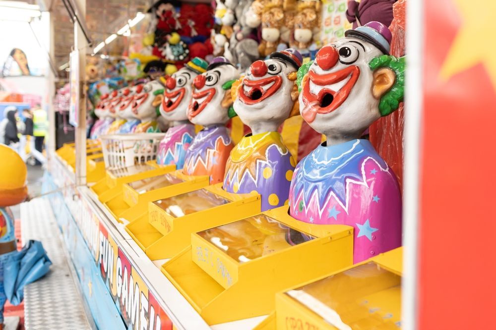 A Bunch of Stuffed Animals Are Hanging on a Fence at a Carnival — Fun Time Amusements in Mackay, QLD
