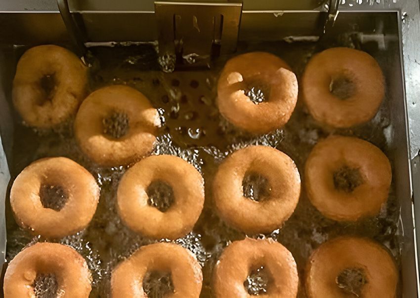 A Bunch of Donuts Are Being Cooked in a Fryer — Fun Time Amusements in Hervey Bay, QLD