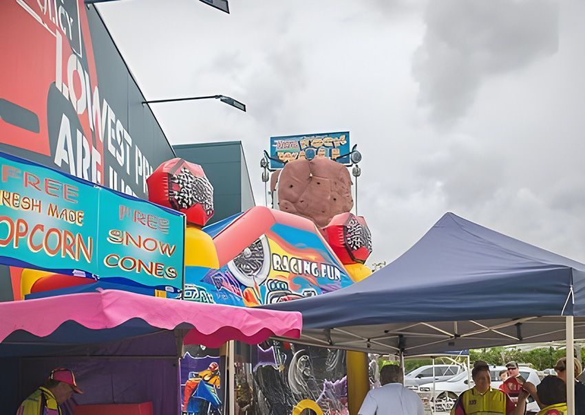 A Group of People Standing Under Tents at a Carnival — Fun Time Amusements in Gracemere, QLD