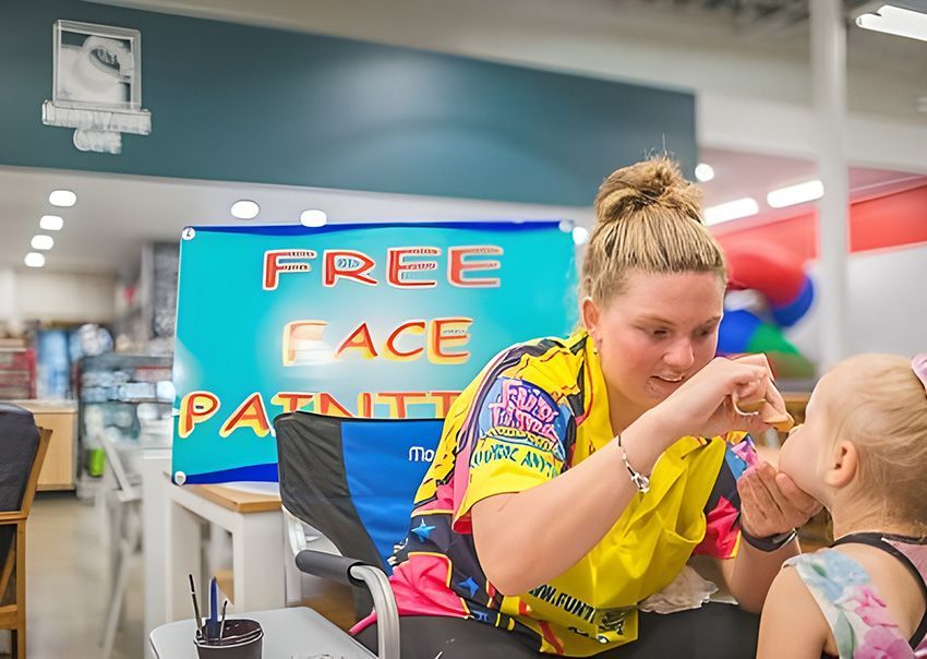 A Woman is Painting a Baby's Face in a Store — Fun Time Amusements in Gracemere, QLD