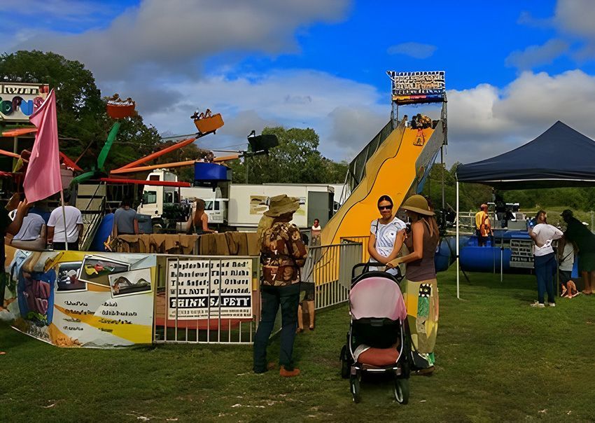A Group of People Standing in Front of a Slide — Fun Time Amusements in Gracemere, QLD