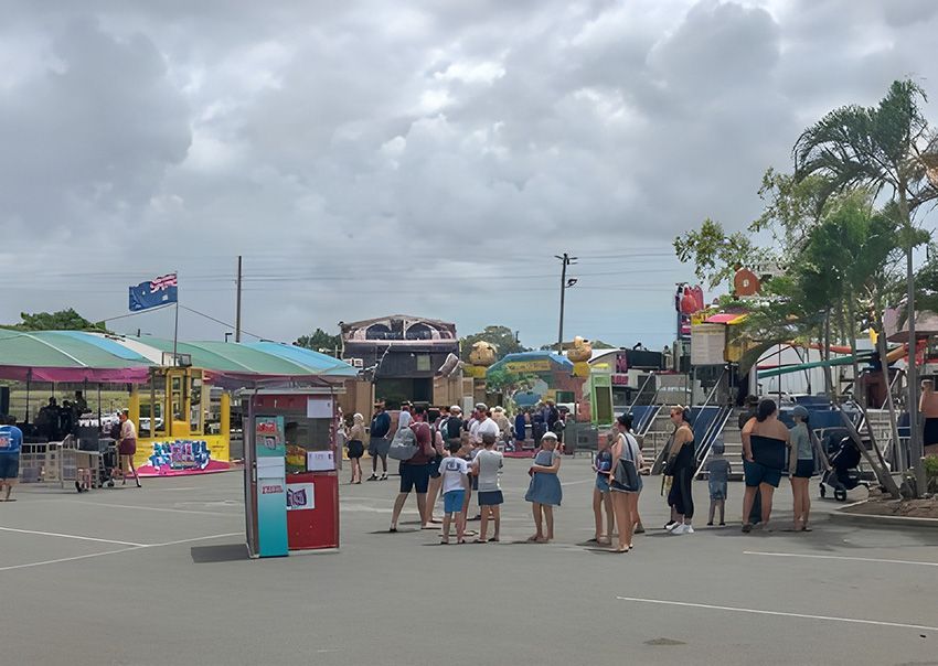 A Group of People Are Standing in a Parking Lot at a Carnival — Fun Time Amusements in Gracemere, QLD