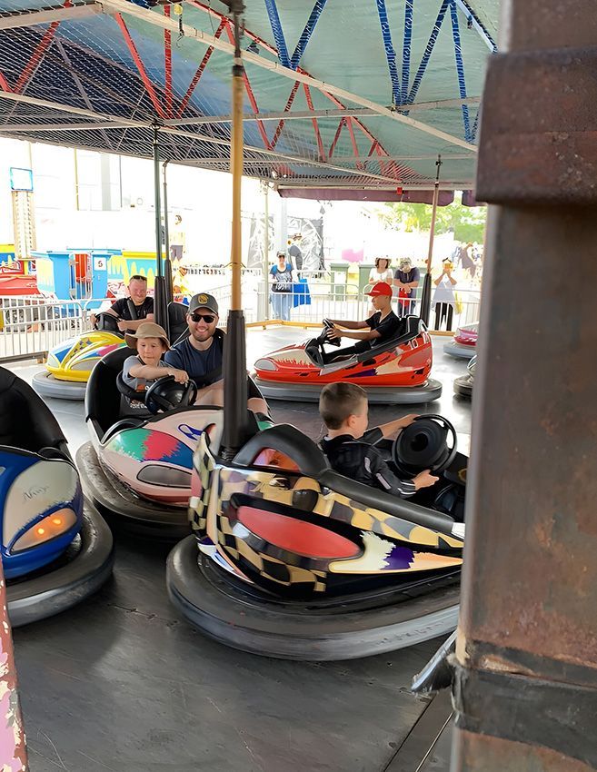 A Group of People Are Riding Bumper Cars at a Carnival — Fun Time Amusements in Gracemere, QLD