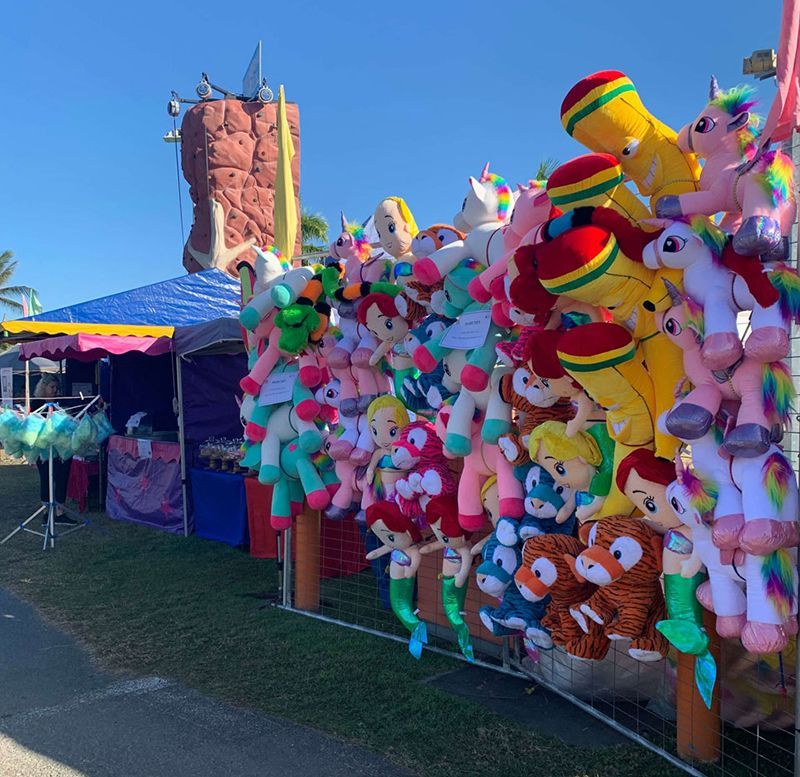 A Bunch of Stuffed Animals Are Hanging From a Fence — Fun Time Amusements in Gracemere, QLD