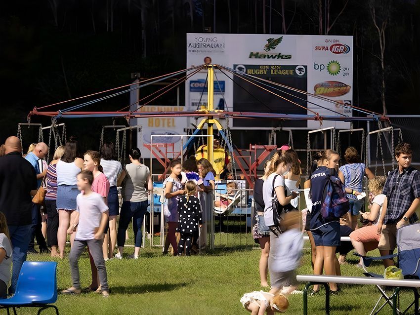 A Group of People Are Gathered in a Field — Fun Time Amusements in Gracemere, QLD