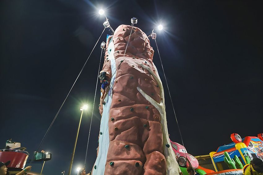 A Person is Climbing a Climbing Wall at Night — Fun Time Amusements in Hervey Bay, QLD