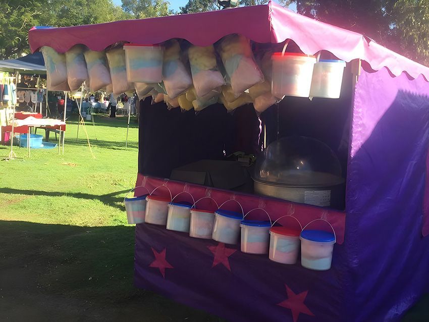 A Purple Tent With Buckets of Cotton Candy Hanging From It — Fun Time Amusements in Gracemere, QLD