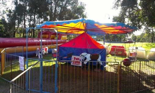 Carousel Ride in a Park With Blue, Red, and Yellow Canopy — Fun Time Amusements in Gracemere, QLD