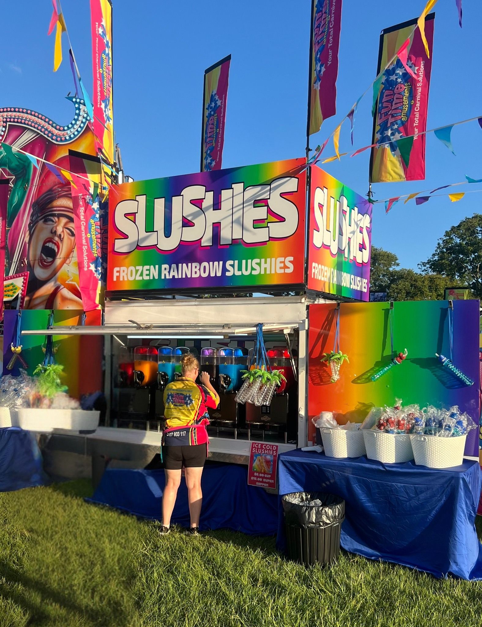 Slushie Stand at Night, With a Rainbow Sign and People Ordering — Fun Time Amusements in Gracemere, QLD